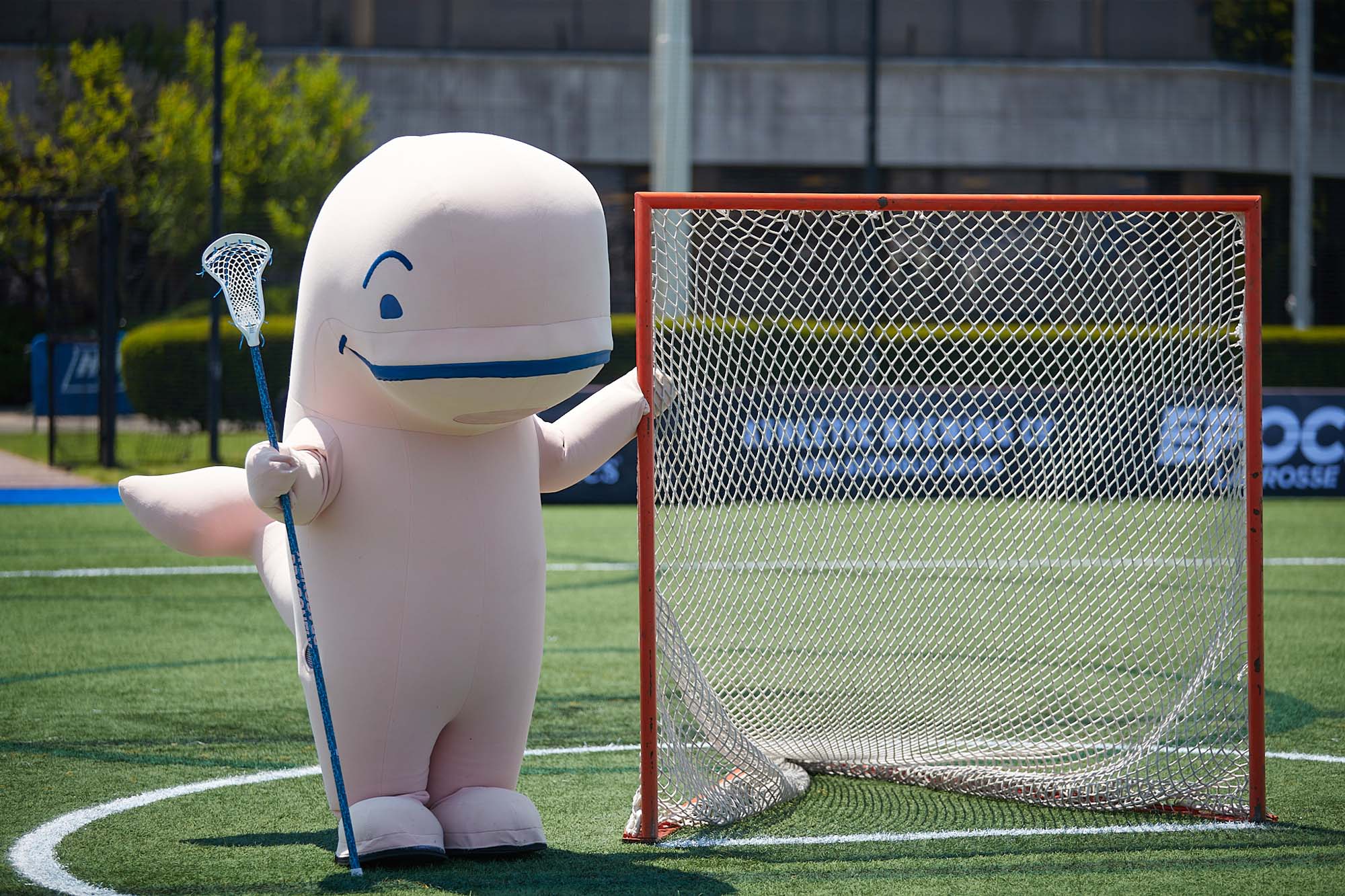 vineyard vines whale mascot playing lacrosse