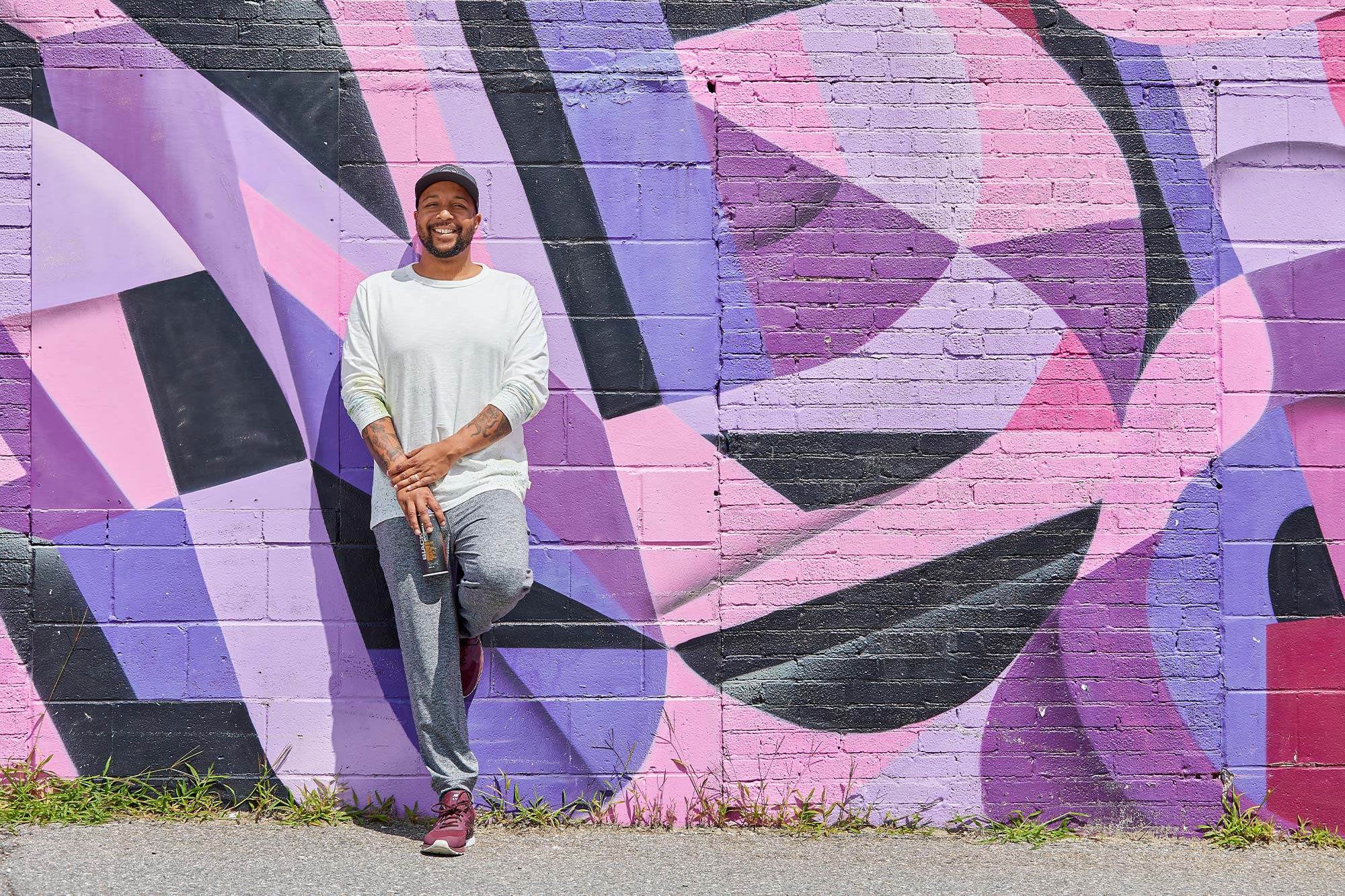Ryan Adams posing next to mural