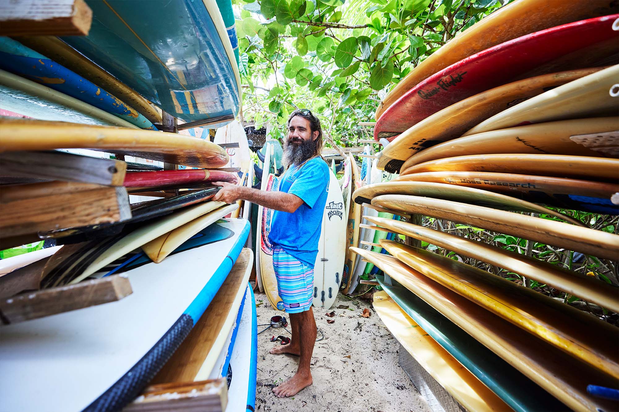 Steve Howes posing with surfboards