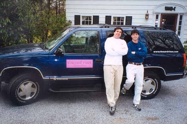 Shep and Ian Murray standing next to Chevrolet Tahoe with vineyard vines logo
