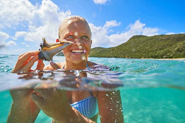 woman holding seashell
